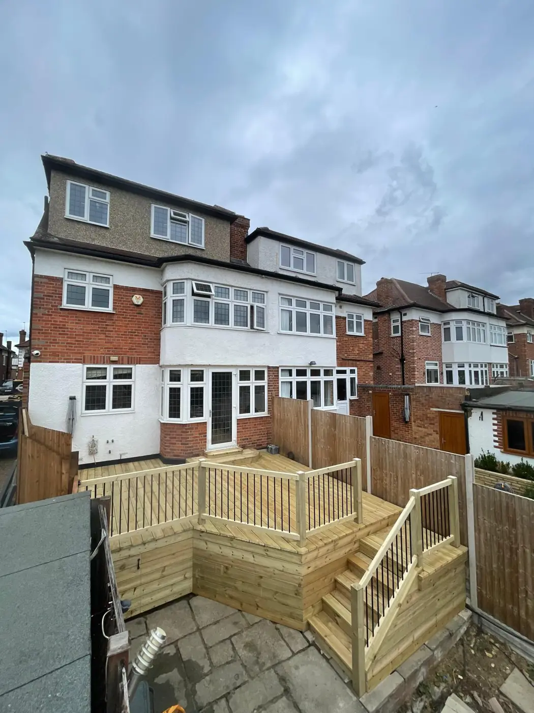 Fresh timber decking with balustrades and steps leading into a garden