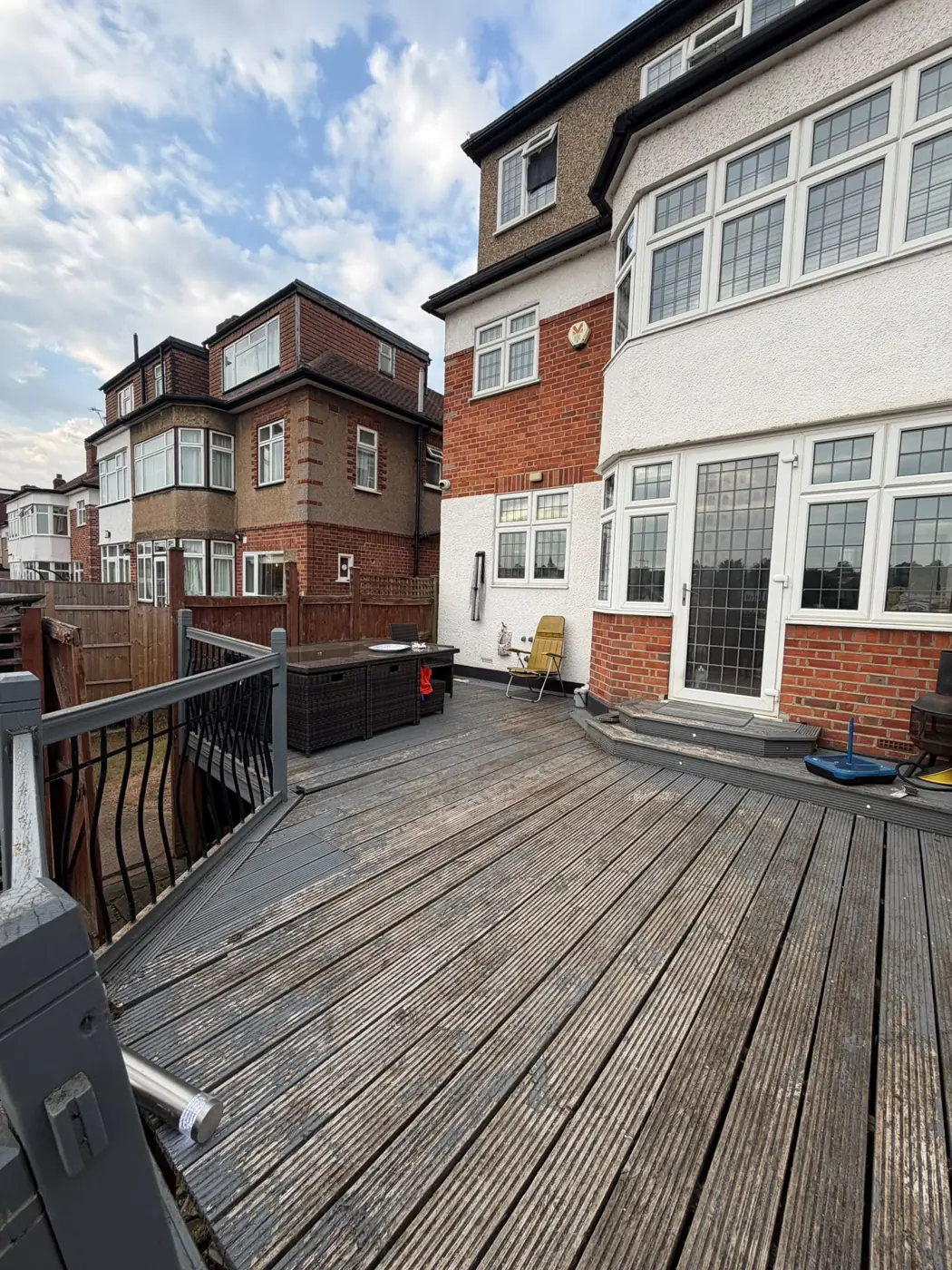Older raised timber deck beside the rear of a house
