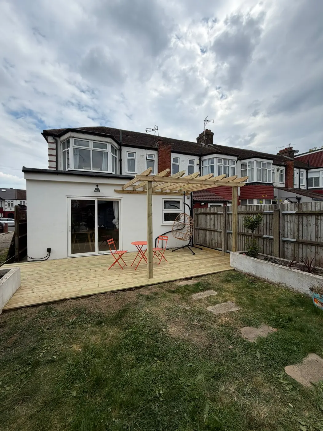 Timber deck outside rear garden doors, adjoining the lawn