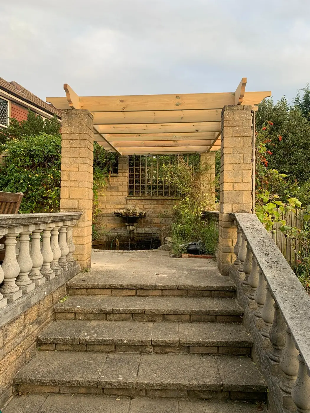Front view of timber pergola over stone garden steps